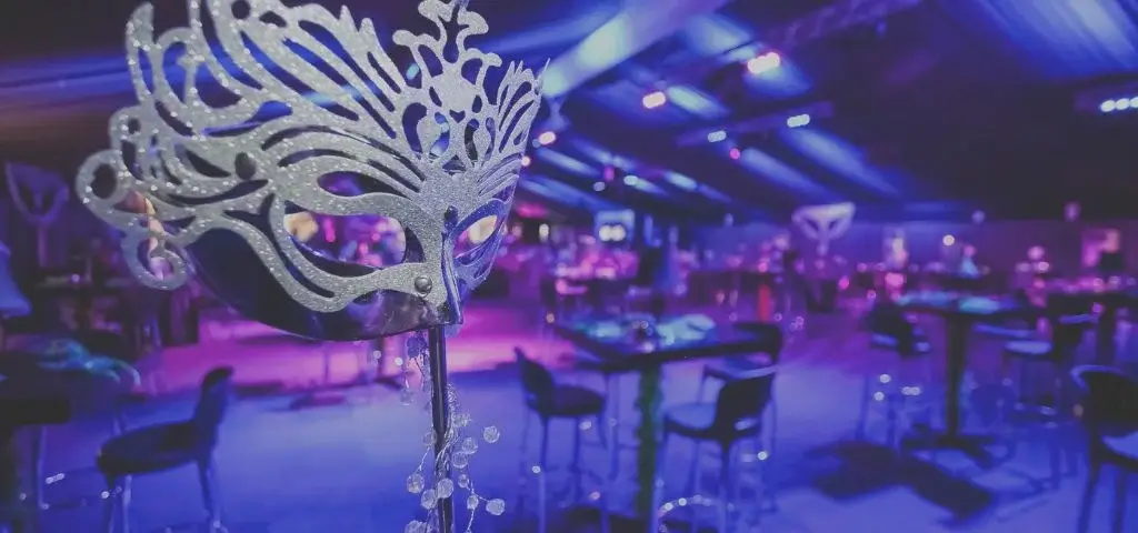 Masquerade themed gala event with purple lighting in Dubai